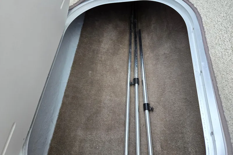 Slide: The Image of Storage compartment in 1998 Four Winns 180 Horizon boat with metal poles inside. - 14
