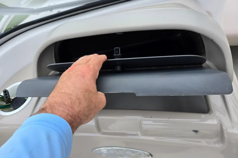 Slide: The Image of Hand opening glove compartment on 1998 Four Winns 180 Horizon boat. - 16