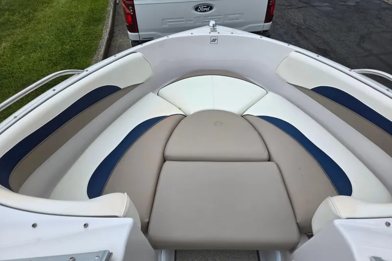 Slide: The Image of 1998 Four Winns 180 Horizon boat interior with beige and blue seating. - 17