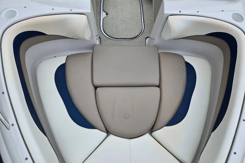 Slide: The Image of 1998 Four Winns 180 Horizon boat interior with cushioned seating and blue accents. - 18