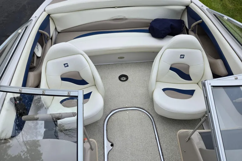 Slide: The Image of 1998 Four Winns 180 Horizon boat interior with white and blue seating. - 20
