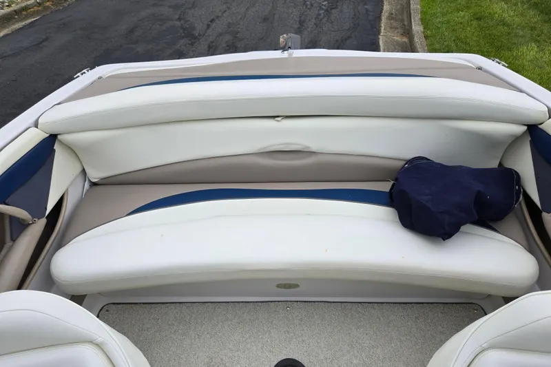 Slide: The Image of 1998 Four Winns 180 Horizon boat interior with white and blue seating. - 21