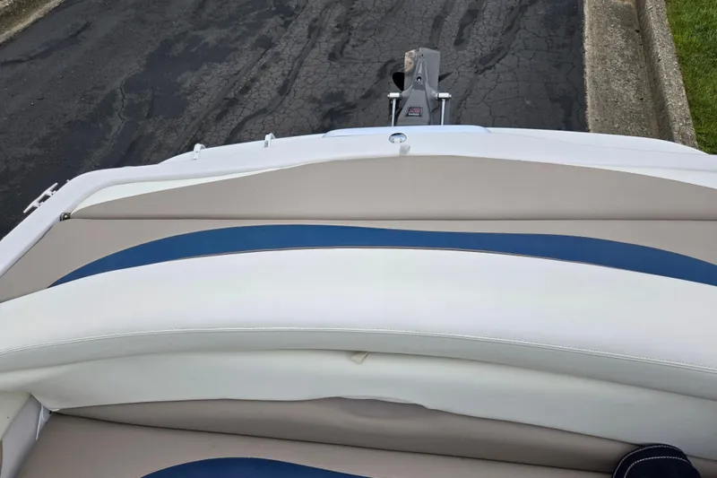 Slide: The Image of 1998 Four Winns 180 Horizon boat interior with beige and blue seating. - 22