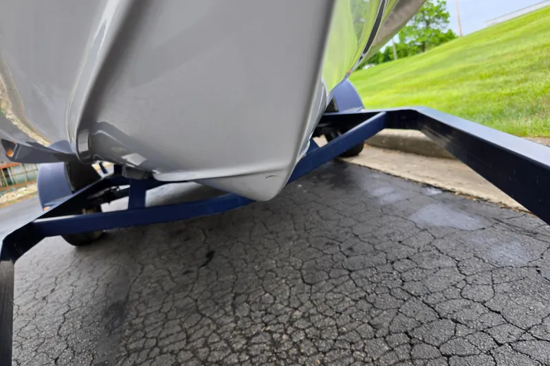 Slide: The Image of 1998 Four Winns 180 Horizon boat on trailer, close-up view of hull and pavement. - 7