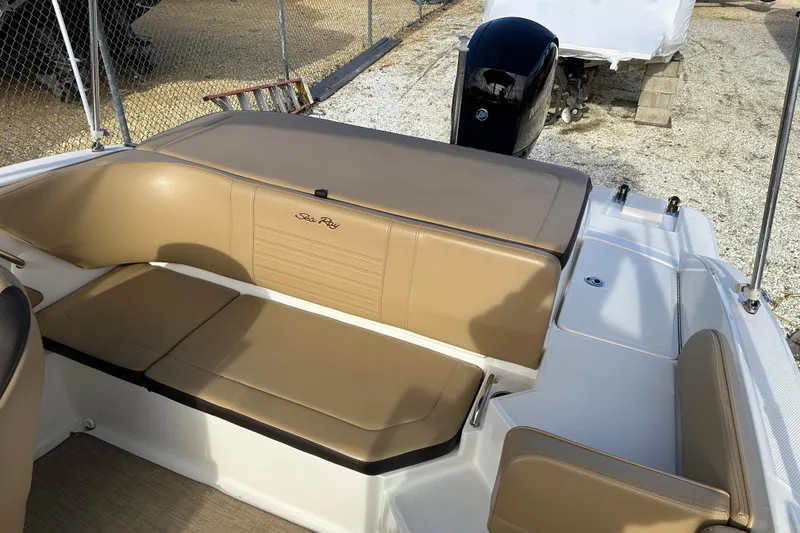 Slide: The Image of 2020 Sea Ray SPX 190 Outboard boat interior with tan seating and outboard motor. - 13