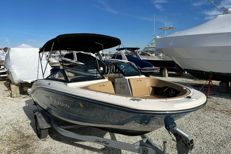 Slide: The Image of 2020 Sea Ray SPX 190 Outboard boat on trailer, parked in marina under clear sky. - 21