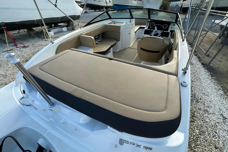 Slide: The Image of 2020 Sea Ray SPX 190 Outboard boat interior with beige seating and steering wheel. - 5