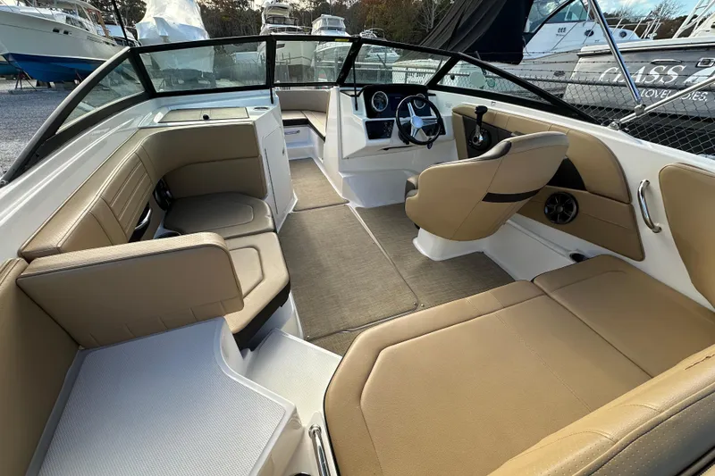 Slide: The Image of 2020 Sea Ray SPX 190 Outboard interior with tan seating and modern dashboard. - 6