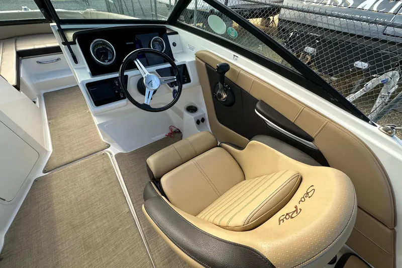 Slide: The Image of 2020 Sea Ray SPX 190 Outboard boat interior with steering wheel and beige seating. - 7