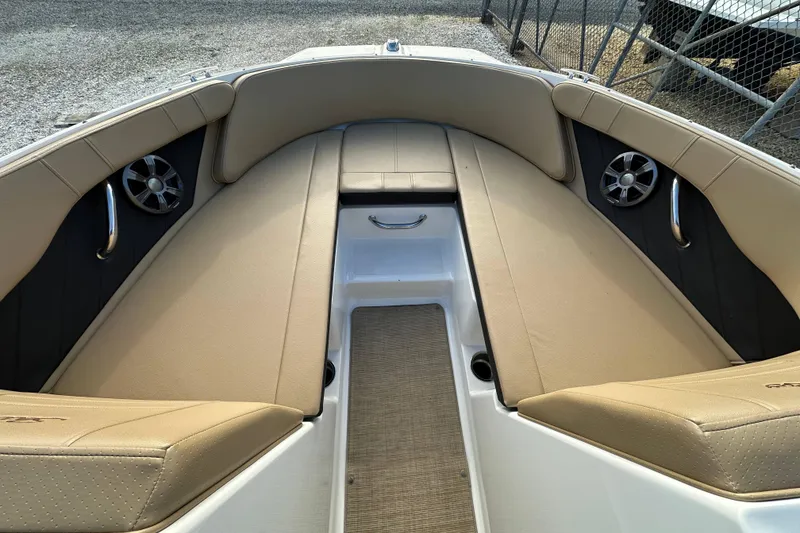 Slide: The Image of 2020 Sea Ray SPX 190 Outboard boat interior with beige seating and speakers. - 9