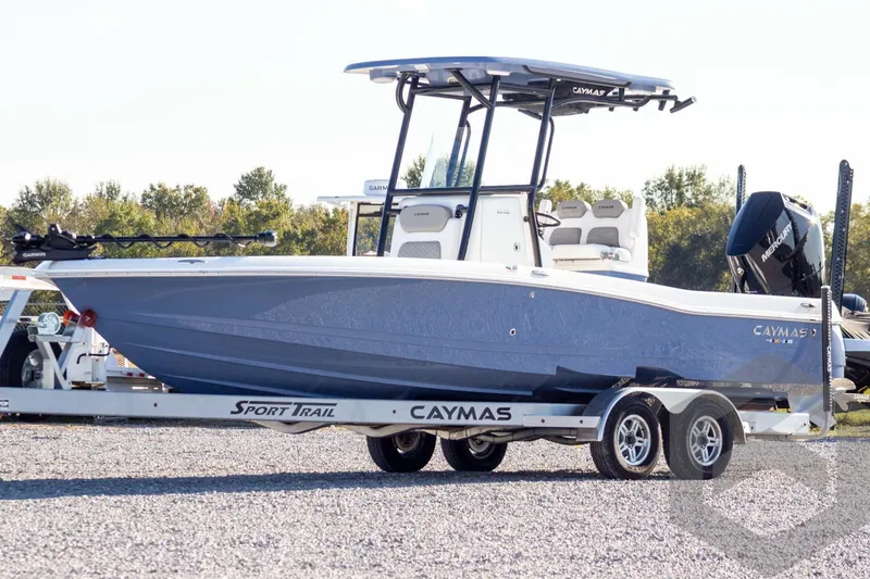 Slide: The Image of 2026 Caymas 26 HB boat on trailer, parked outdoors, side view. - 1