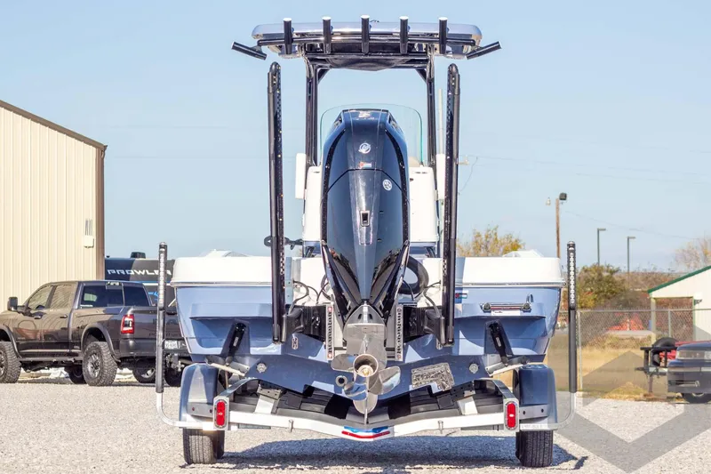 Slide: The Image of 2026 Caymas 26 HB boat on trailer, rear view with outboard motor. - 10