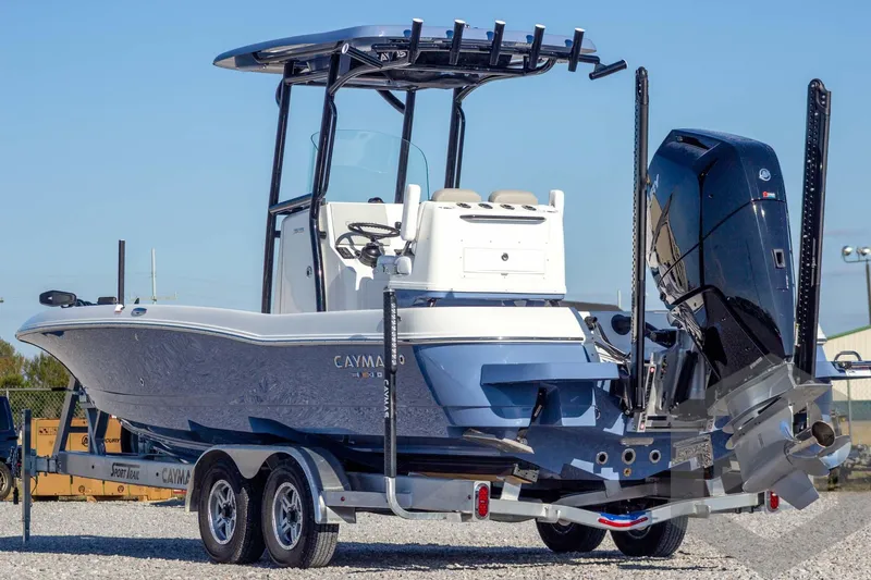 Slide: The Image of 2026 Caymas 26 HB boat on trailer, featuring sleek design and powerful outboard motor. - 11
