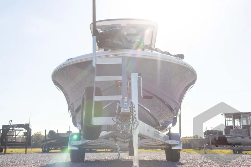 Slide: The Image of 2026 Caymas 26 HB boat on trailer, sunlit, front view. - 13