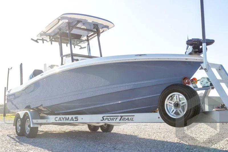Slide: The Image of 2026 Caymas 26 HB boat on trailer, side view, outdoors. - 14