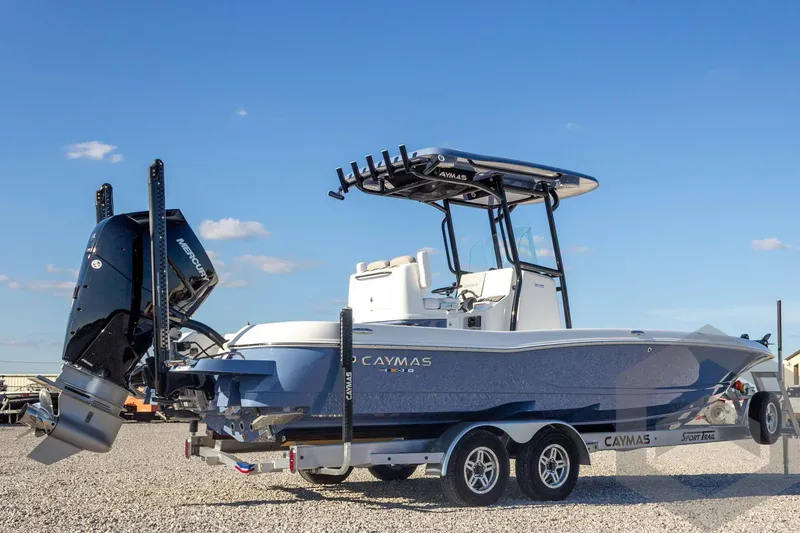 Slide: The Image of 2026 Caymas 26 HB boat on trailer, featuring sleek design and powerful engine. - 16