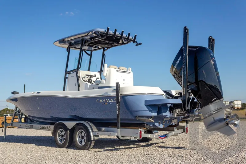 Slide: The Image of 2026 Caymas 26 HB boat on trailer, featuring sleek design and powerful outboard motor. - 18