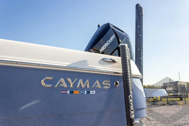Slide: The Image of 2026 Caymas 26 HB boat with Mercury engine, displayed outdoors under clear blue sky. - 20