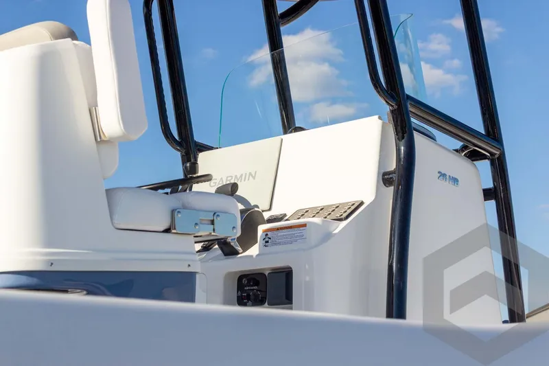 Slide: The Image of 2026 Caymas 26 HB boat console with Garmin equipment, under a clear blue sky. - 23