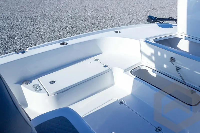 Slide: The Image of 2026 Caymas 26 HB boat interior with storage compartments and seating area. - 27