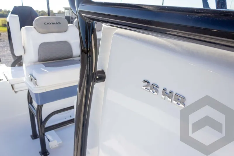Slide: The Image of 2026 Caymas 26 HB boat interior with seating and model emblem. - 37