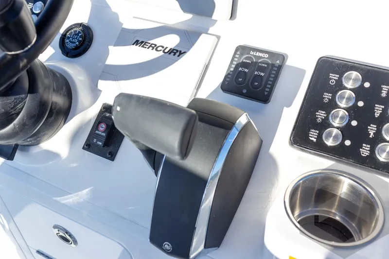 Slide: The Image of Control panel of 2026 Caymas 26 HB boat featuring Mercury throttle and switches. - 48