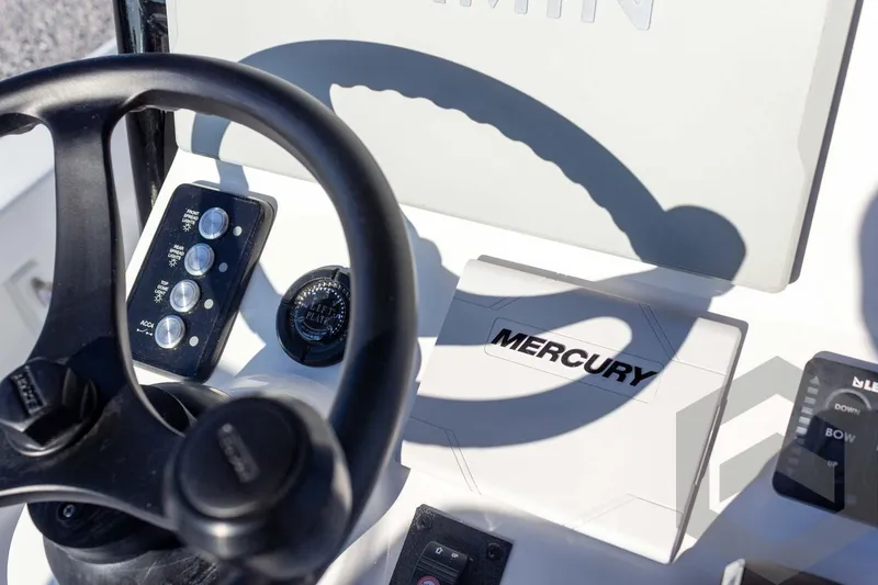 Slide: The Image of Steering wheel and controls of 2026 Caymas 26 HB boat with Mercury system. - 49