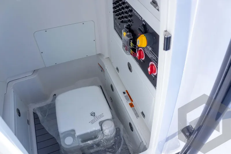 Slide: The Image of 2026 Caymas 26 HB boat interior with control panel and storage compartment. - 56