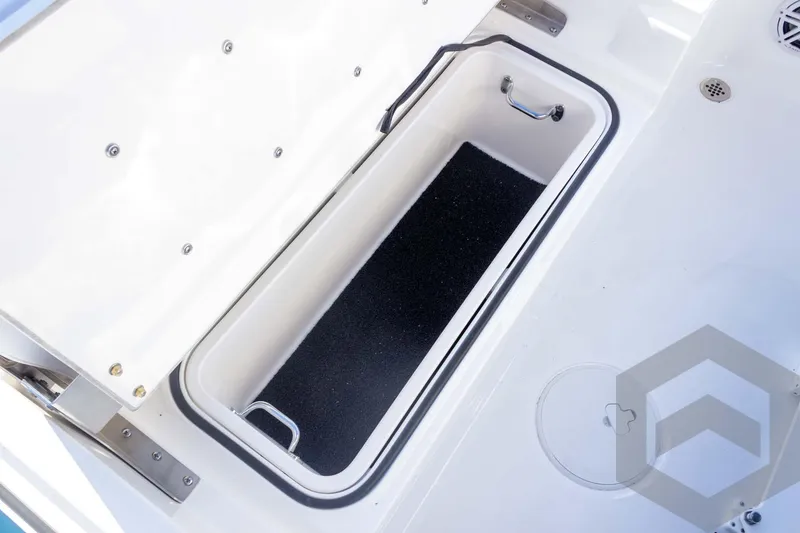 Slide: The Image of 2026 Caymas 26 HB boat storage compartment with stainless steel handles and non-slip interior. - 59