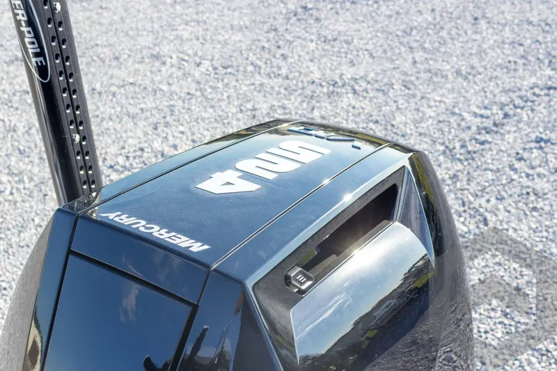 Slide: The Image of 2026 Caymas 26 HB boat with Mercury engine, featuring Power-Pole anchor system. - 63