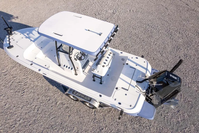 Slide: The Image of 2026 Caymas 26 HB boat on trailer, aerial view, featuring Mercury engine. - 71