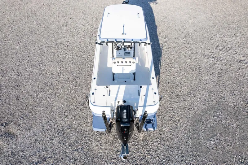 Slide: The Image of 2026 Caymas 26 HB boat, aerial view, on gravel surface. - 72