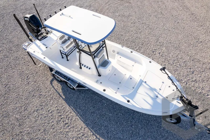 Slide: The Image of 2026 Caymas 26 HB boat on trailer, aerial view, parked on gravel surface. - 75