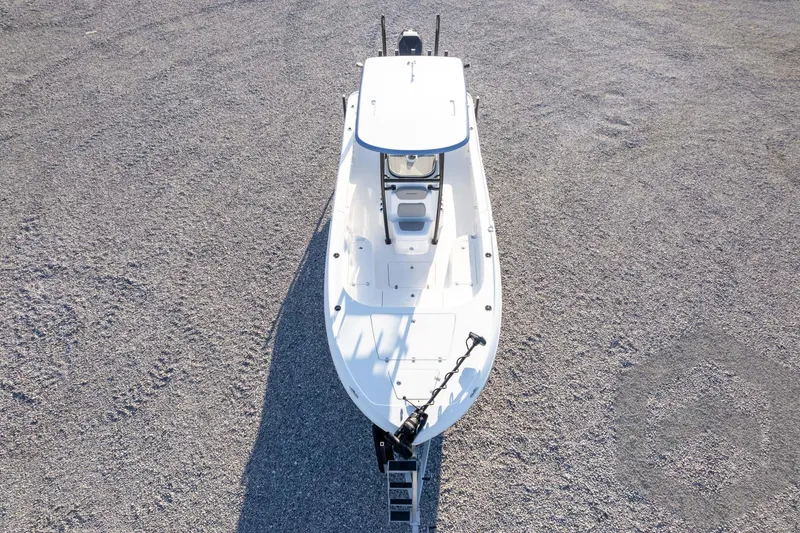 Slide: The Image of 2026 Caymas 26 HB boat on gravel, aerial view showcasing sleek design. - 76