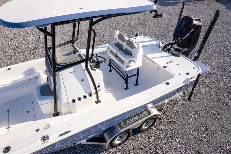 Slide: The Image of 2026 Caymas 26 HB boat with dual seats and Mercury engine on a trailer. - 77