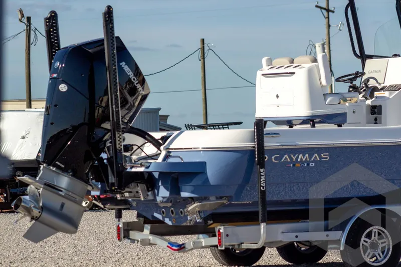 Slide: The Image of 2026 Caymas 26 HB boat with Mercury engine on trailer, outdoor setting. - 8