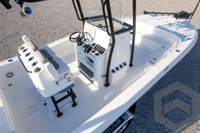 Slide: The Image of 2026 Caymas 26 HB boat interior with steering console and seating. - 80