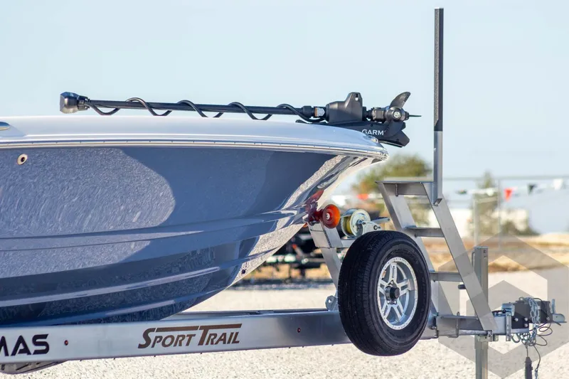 Slide: The Image of 2026 Caymas 26 HB boat on Sport Trail trailer, close-up view. - 9