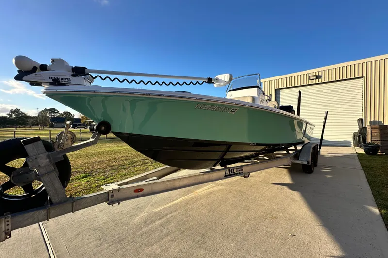 Slide: The Image of 2023 Sportsman Tournament 234 Bay Boat on trailer, parked outdoors under clear sky. - 10