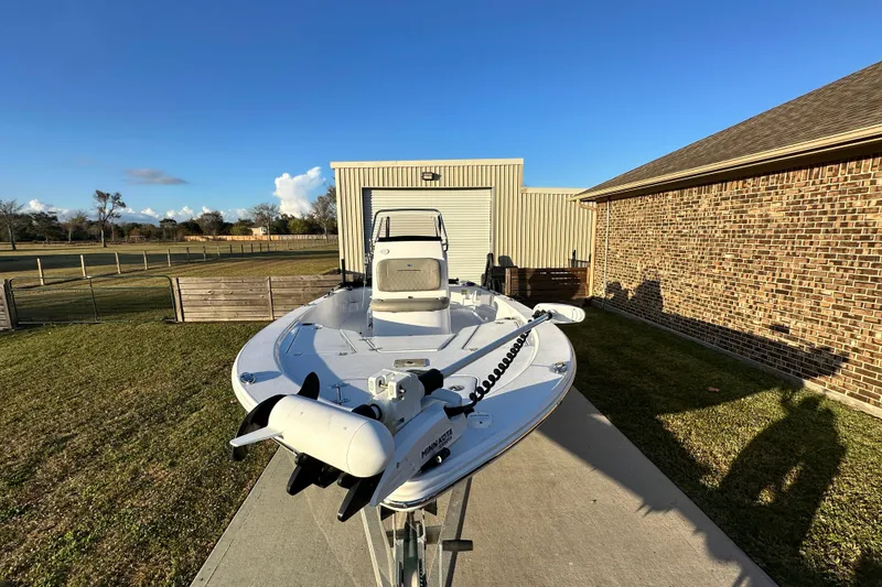 Slide: The Image of 2023 Sportsman Tournament 234 Bay Boat parked on driveway under clear blue sky. - 14