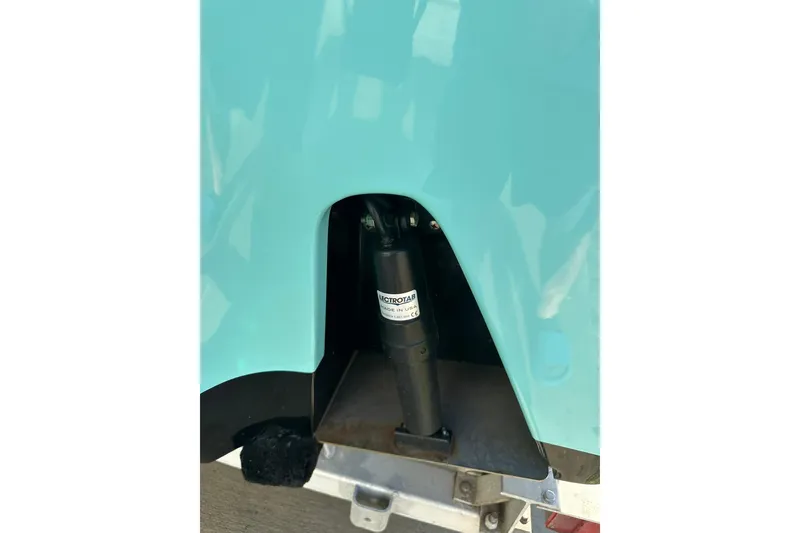 Slide: The Image of 2023 Sportsman Tournament 234 Bay Boat trim tab detail in turquoise. - 15