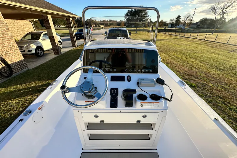 Slide: The Image of 2023 Sportsman Tournament 234 Bay Boat console with steering wheel and controls. - 25