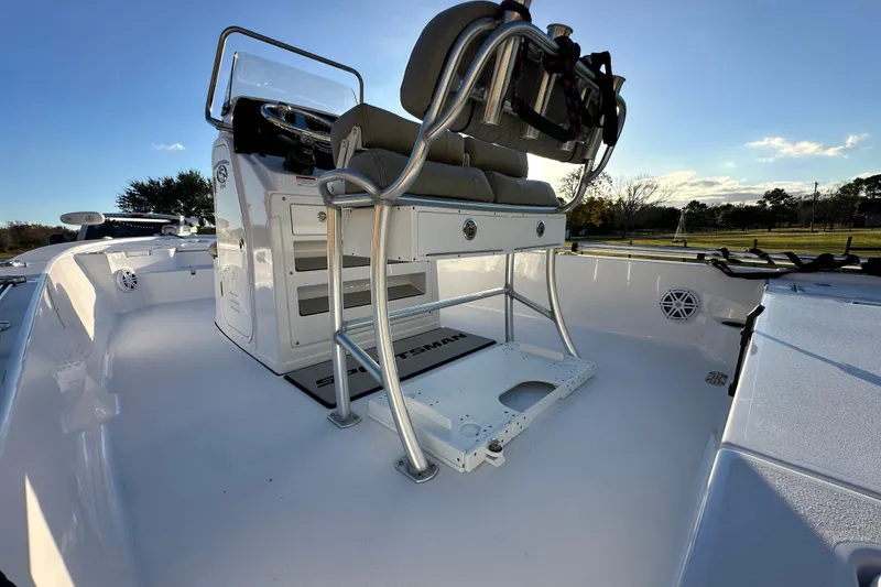 Slide: The Image of 2023 Sportsman Tournament 234 Bay Boat interior with seating and console, under clear sky. - 28