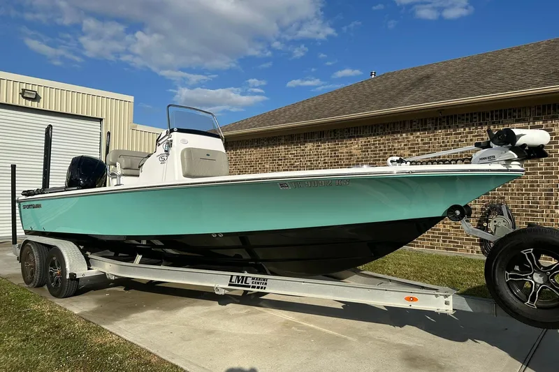 Slide: The Image of 2023 Sportsman Tournament 234 Bay Boat on trailer, parked outside a garage. - 3