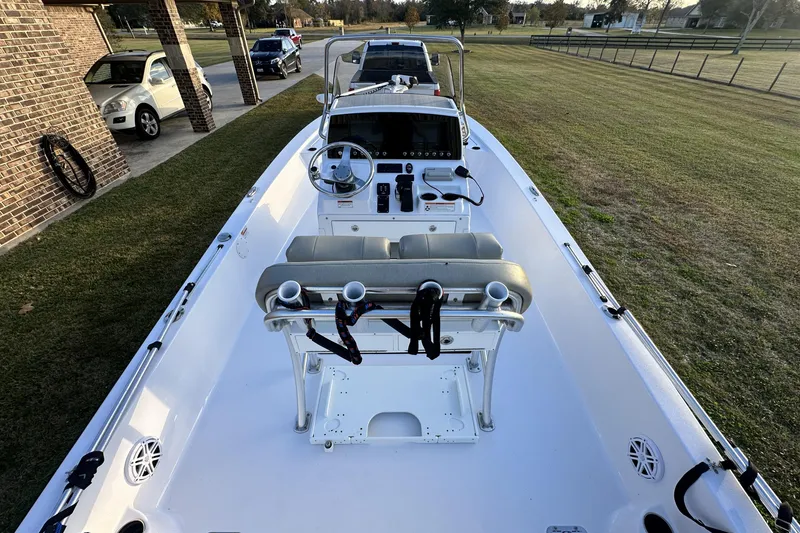 Slide: The Image of 2023 Sportsman Tournament 234 Bay Boat parked on grass, showcasing helm and seating. - 30