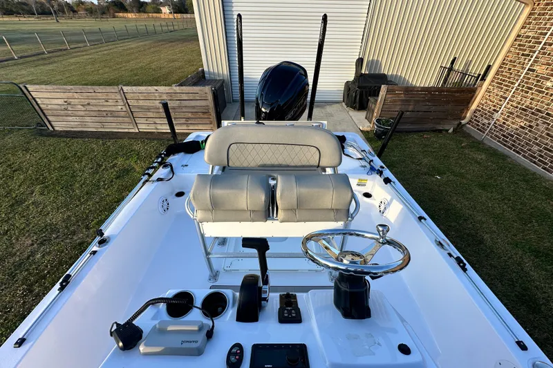 Slide: The Image of 2023 Sportsman Tournament 234 Bay Boat with dual seats and steering wheel, parked outdoors. - 31