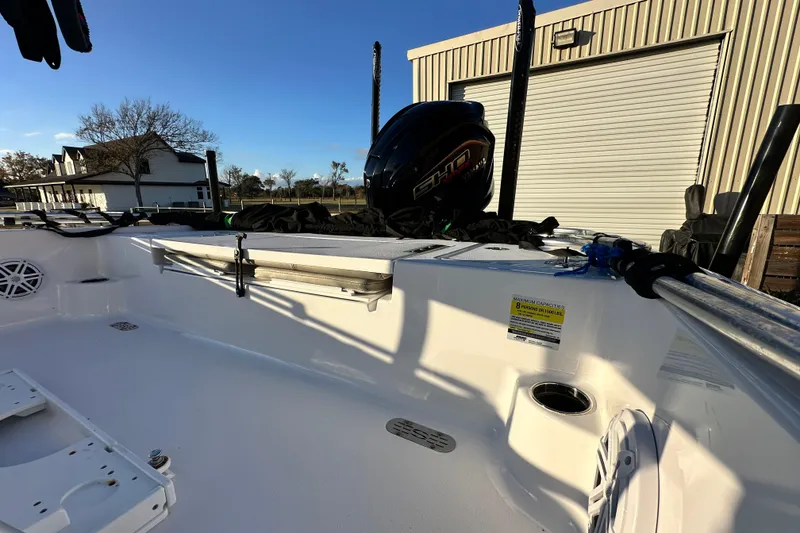 Slide: The Image of 2023 Sportsman Tournament 234 Bay Boat, docked with visible engine and storage area. - 34