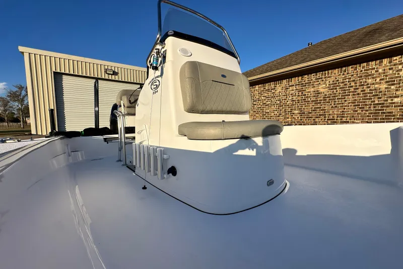 Slide: The Image of 2023 Sportsman Tournament 234 Bay Boat with seating, docked near a brick building. - 36