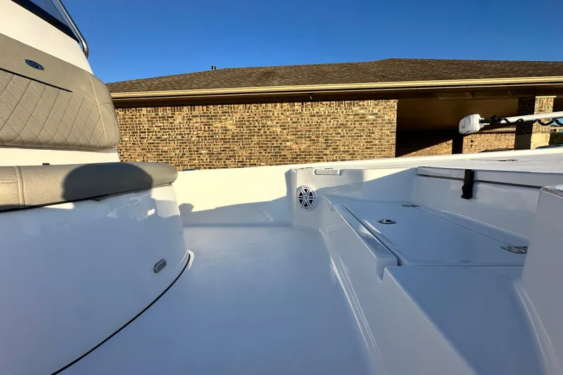 Slide: The Image of 2023 Sportsman Tournament 234 Bay Boat interior with seating and storage, under clear blue sky. - 37