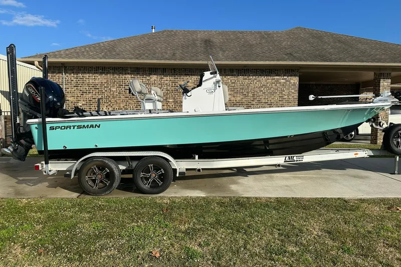 Slide: The Image of 2023 Sportsman Tournament 234 Bay Boat on trailer, parked in driveway. - 4